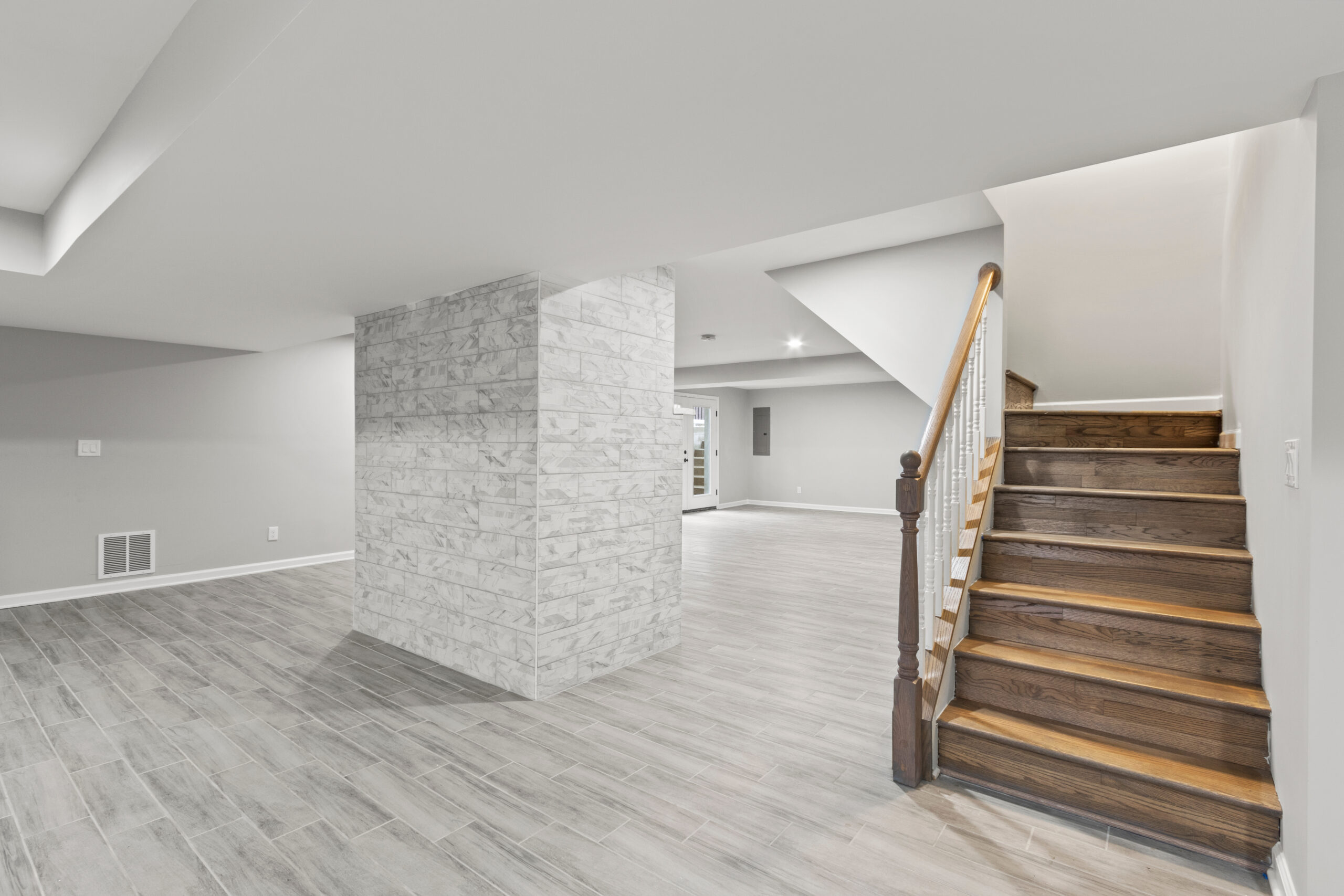 Professionally finished basement renovation in Edmonton with a modern family room, recessed lighting and durable flooring